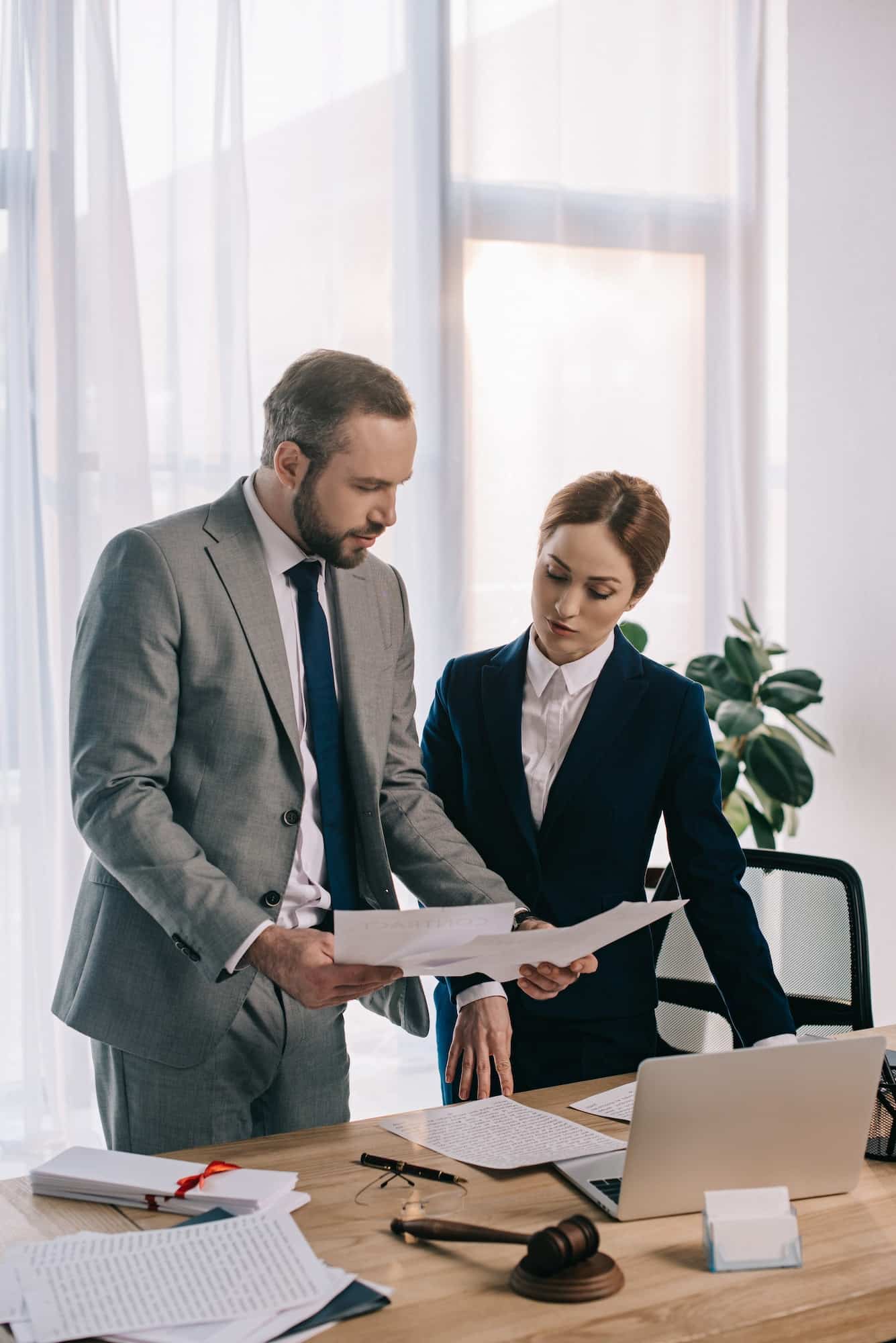 lawyers in suits working together on project at workplace with gavel and laptop in office, Private Equity Lawyer