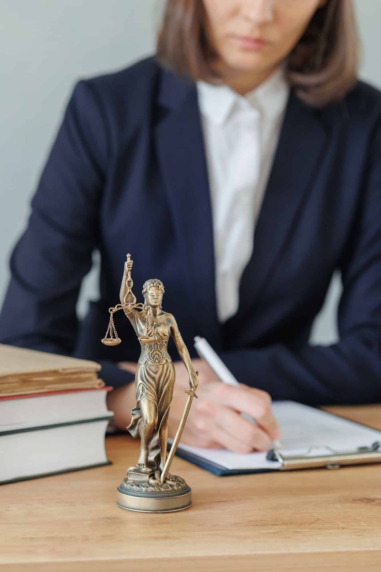 woman lawyer or a court representative sits in the office and checks the legal contract, Property Litigation Lawyer, Employment Law Solicitors London, Data Breach Lawyer