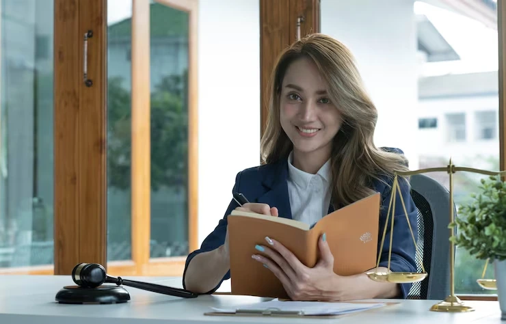 Woman writing at a legal desk.