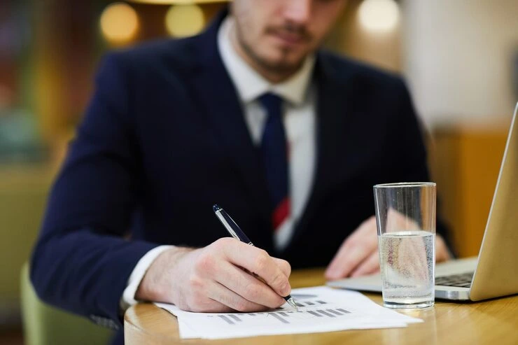 Man signing documents at a desk