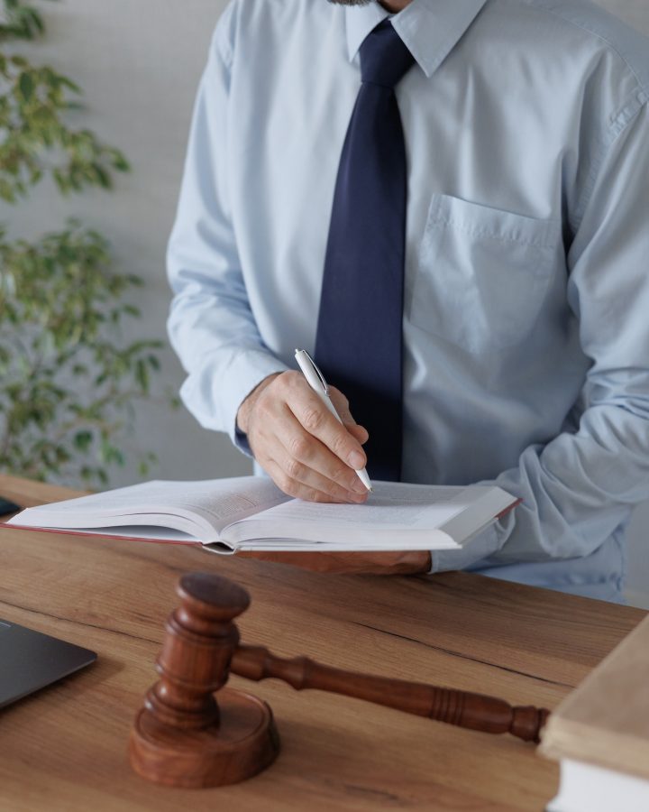 a European male lawyer talks to clients on a webcam from a laptop. work in a law firm or legal
