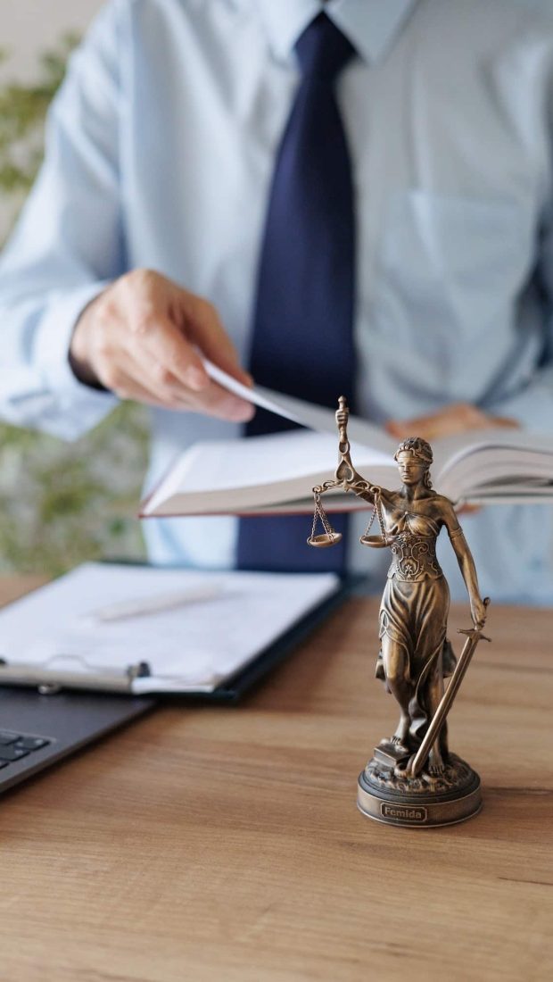 a male lawyer in a blue shirt and tie in the office. legal advice in the office or online, Freehold Solicitors