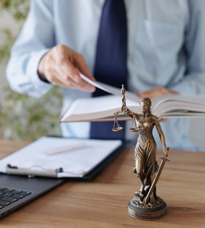 a male lawyer in a blue shirt and tie in the office. legal advice in the office or online, Freehold Solicitors