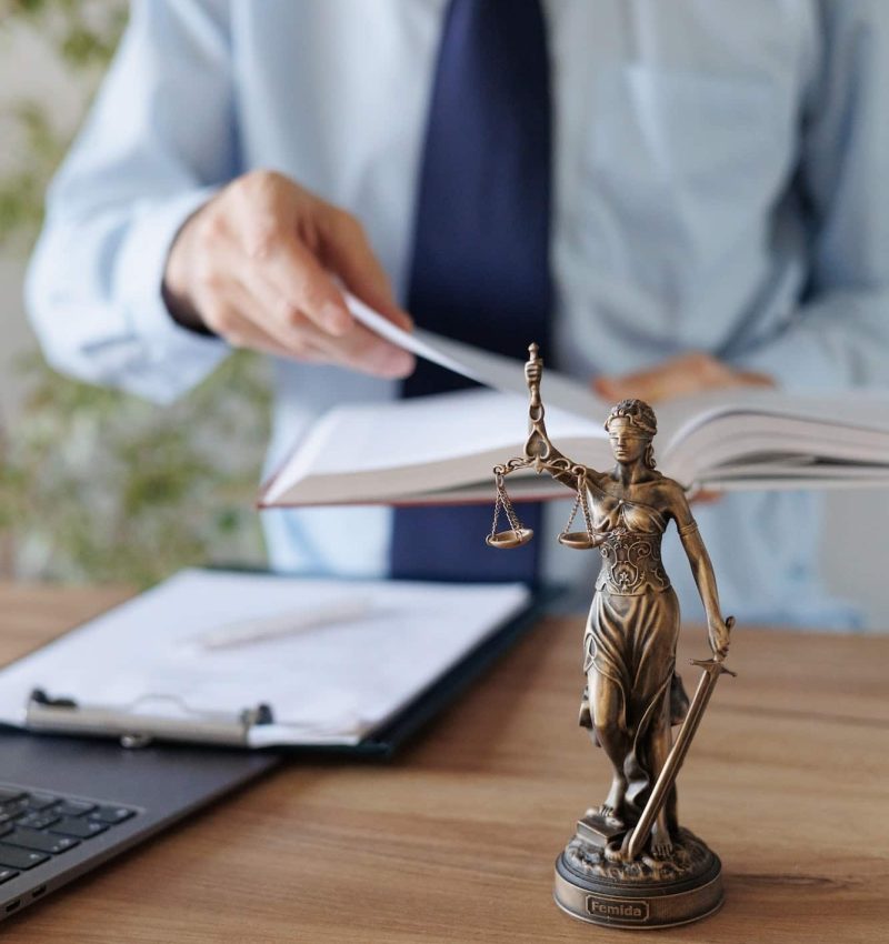 a male lawyer in a blue shirt and tie in the office. legal advice in the office or online, Freehold Solicitors