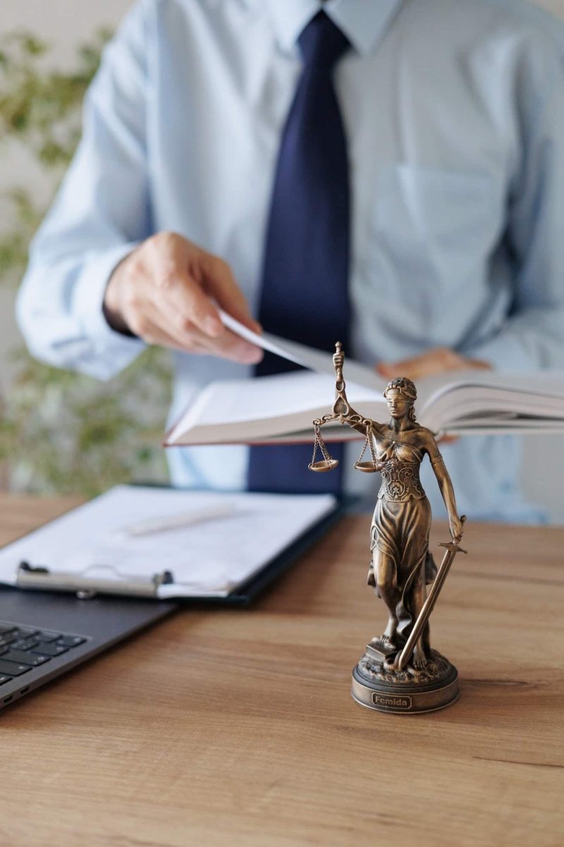 a male lawyer in a blue shirt and tie in the office. legal advice in the office or online, Freehold Solicitors