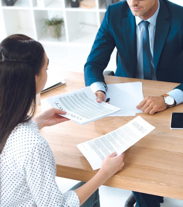 high angle view of lawyer and client discussing contract