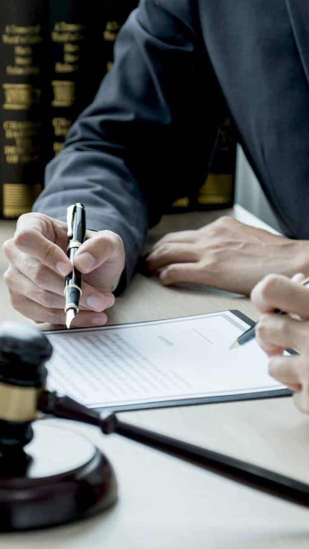 Lawyer hand holding pen and providing legal consult business dispute to the man