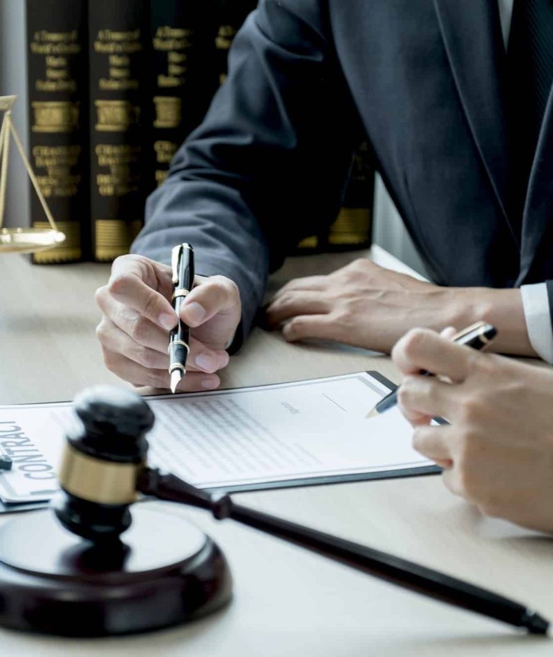 Lawyer hand holding pen and providing legal consult business dispute to the man