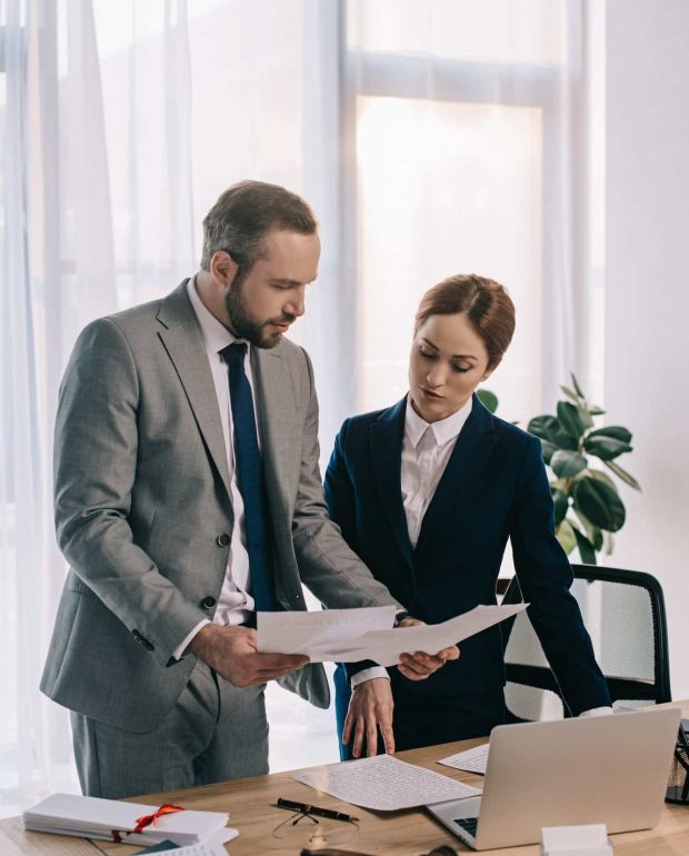 lawyers in suits working together on project at workplace with gavel and laptop in office, Private Equity Lawyer