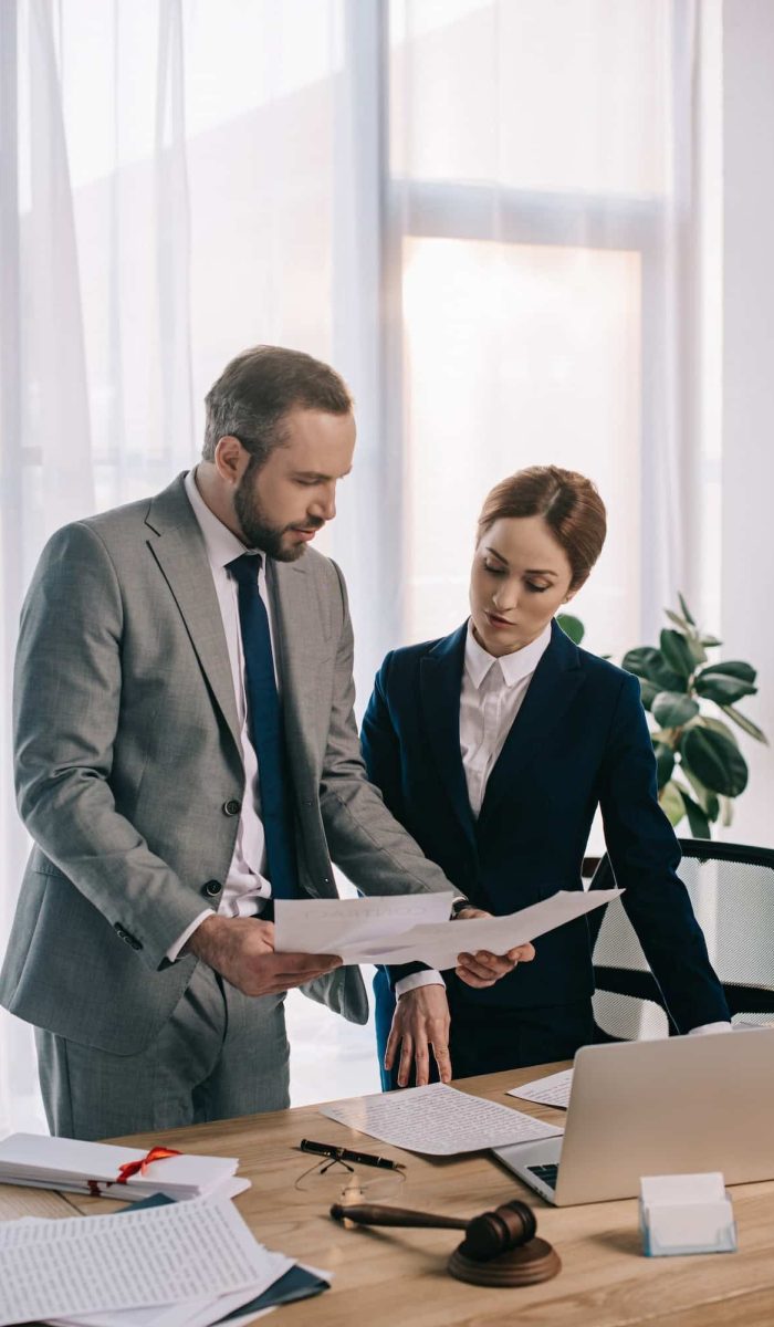 lawyers in suits working together on project at workplace with gavel and laptop in office, Private Equity Lawyer