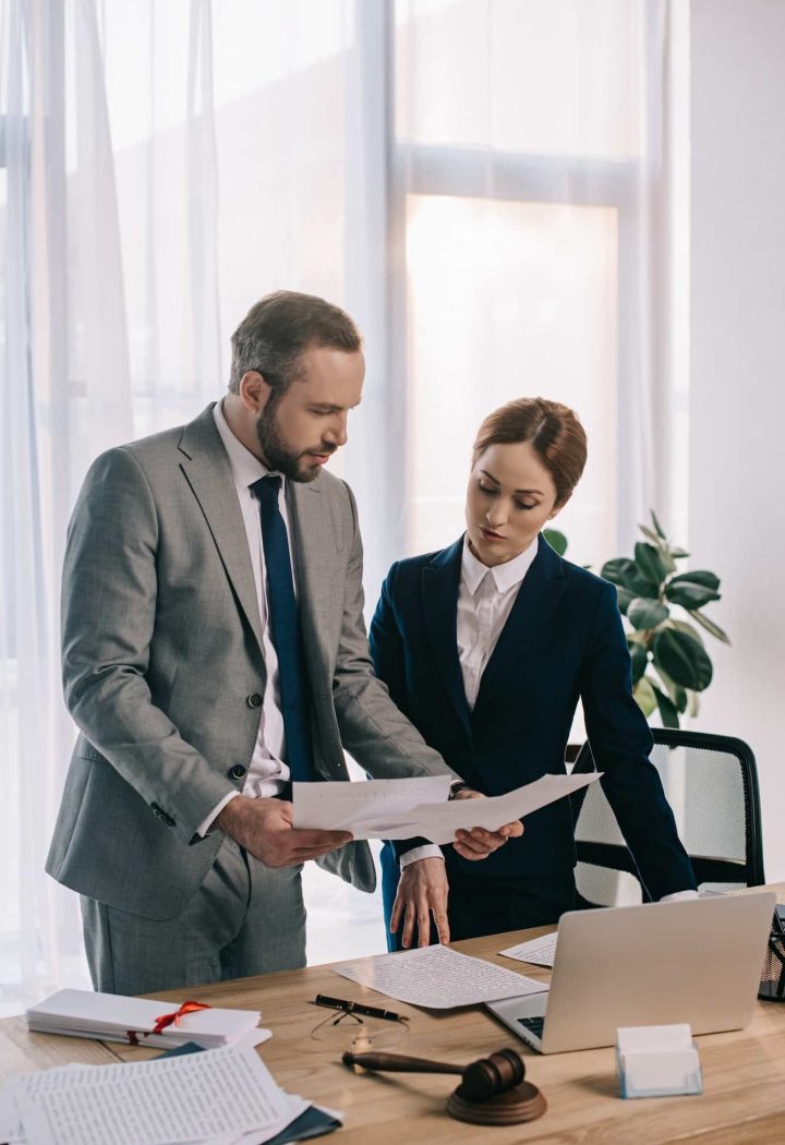 lawyers in suits working together on project at workplace with gavel and laptop in office, Private Equity Lawyer