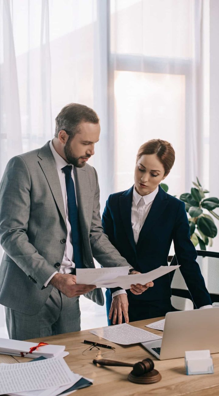 lawyers in suits working together on project at workplace with gavel and laptop in office, Private Equity Lawyer