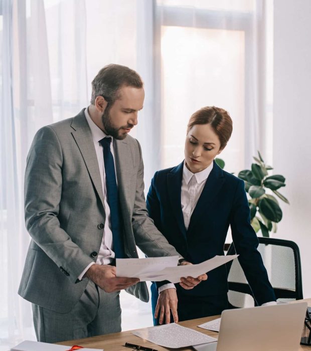 lawyers in suits working together on project at workplace with gavel and laptop in office, Private Equity Lawyer