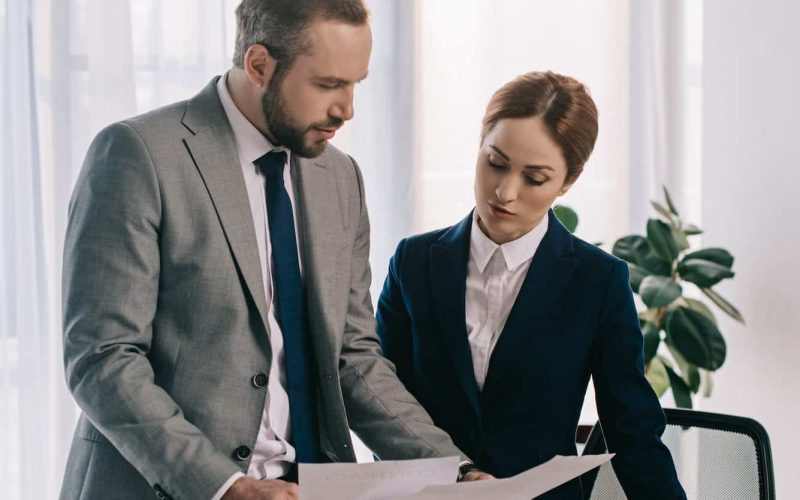 lawyers in suits working together on project at workplace with gavel and laptop in office, Private Equity Lawyer