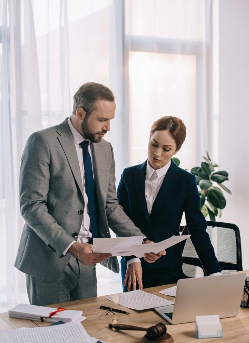 lawyers in suits working together on project at workplace with gavel and laptop in office, Private Equity Lawyer