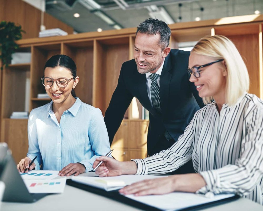 smiling-businesspeople-working-together-at-an-office-table.jpg