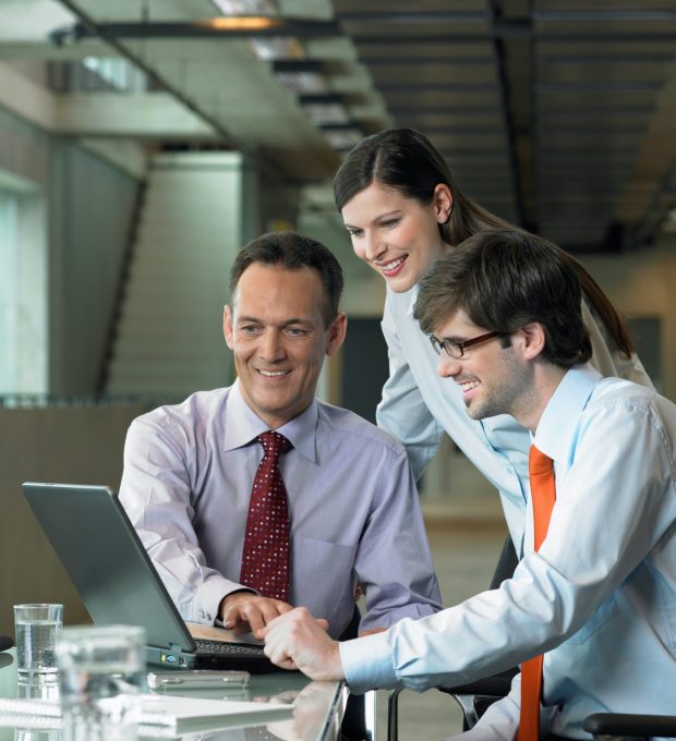 Three Businesspeople looking on laptop, Construction Contract Lawyer, Data Protection Lawyers, Media Lawyer, Surbiton Solicitors