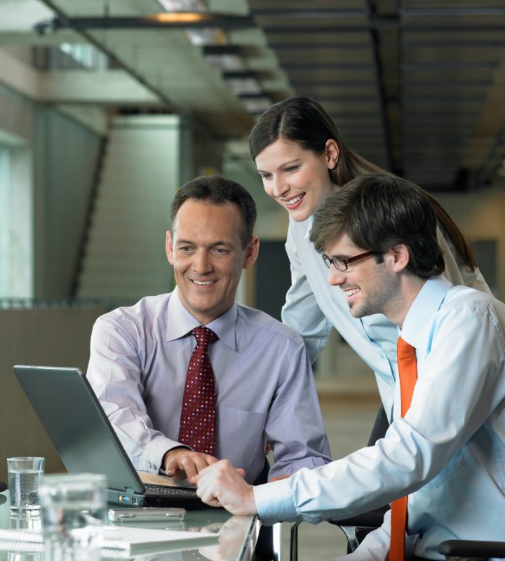 Three Businesspeople looking on laptop, Construction Contract Lawyer, Data Protection Lawyers, Media Lawyer, Surbiton Solicitors