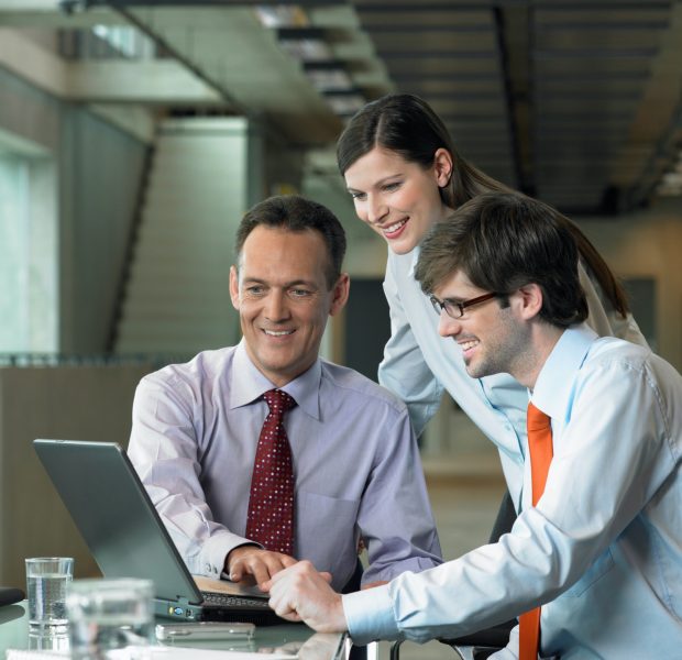 Three Businesspeople looking on laptop, Construction Contract Lawyer, Data Protection Lawyers, Media Lawyer, Surbiton Solicitors