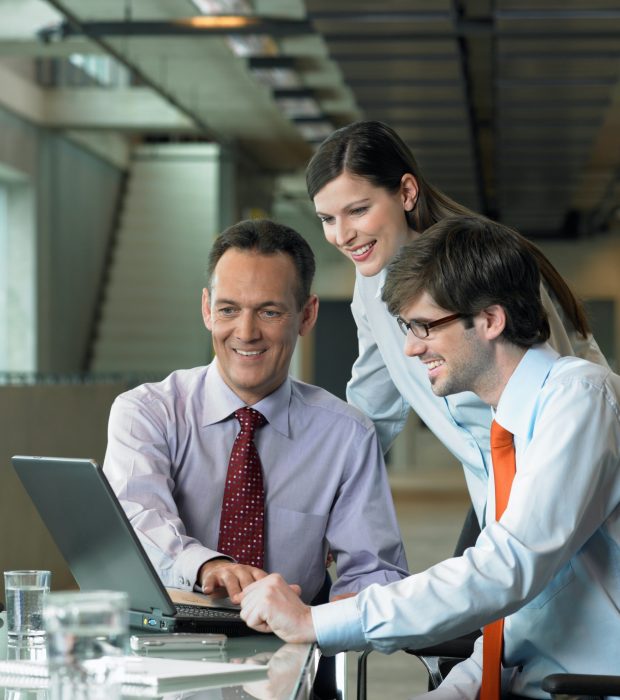 Three Businesspeople looking on laptop, Construction Contract Lawyer, Data Protection Lawyers, Media Lawyer, Surbiton Solicitors