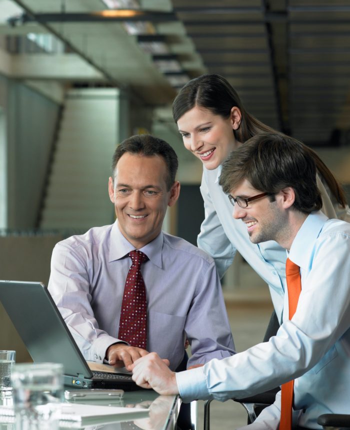 Three Businesspeople looking on laptop, Construction Contract Lawyer, Data Protection Lawyers, Media Lawyer, Surbiton Solicitors