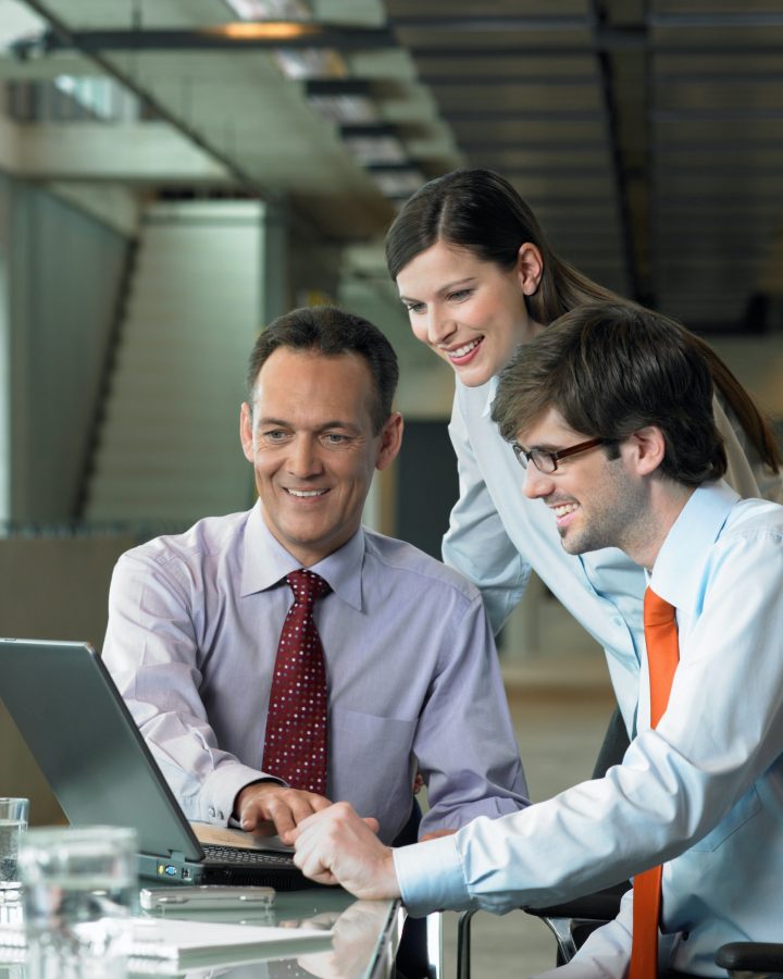 Three Businesspeople looking on laptop, Construction Contract Lawyer, Data Protection Lawyers, Media Lawyer, Surbiton Solicitors