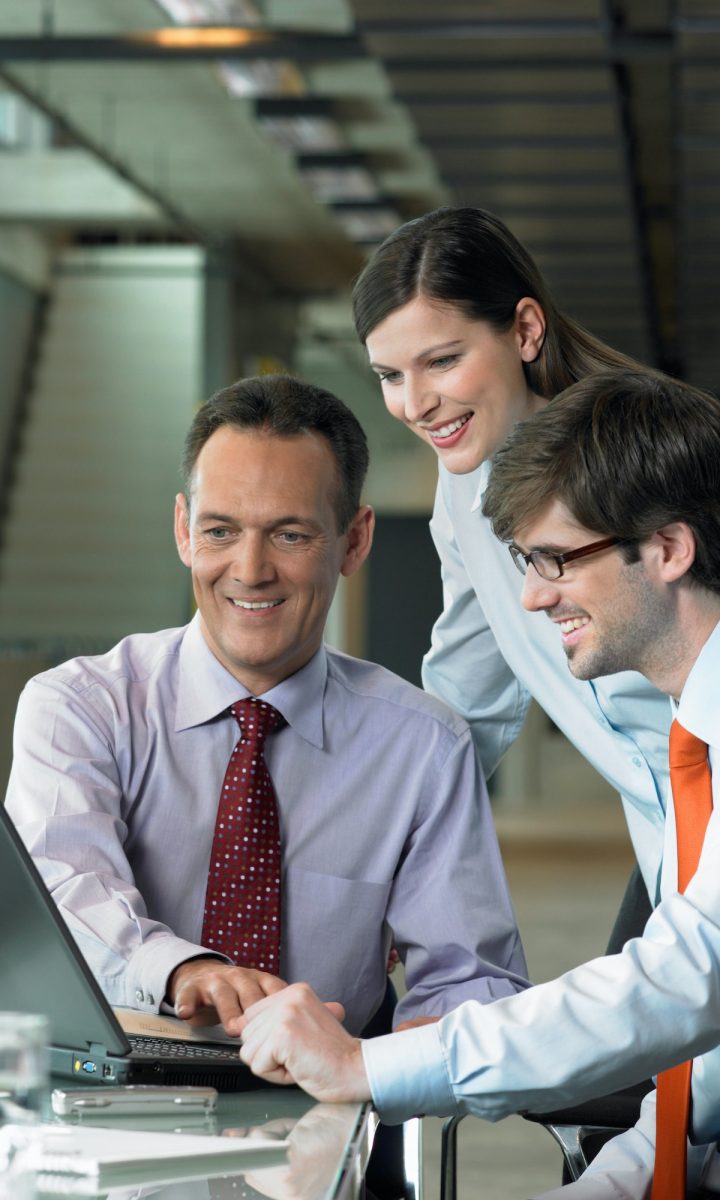 Three Businesspeople looking on laptop, Construction Contract Lawyer, Data Protection Lawyers, Media Lawyer, Surbiton Solicitors