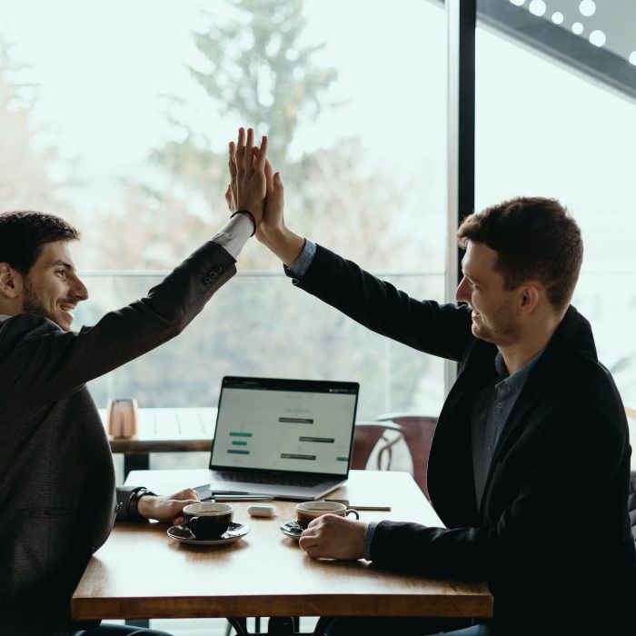 Two business men celebrating a deal
