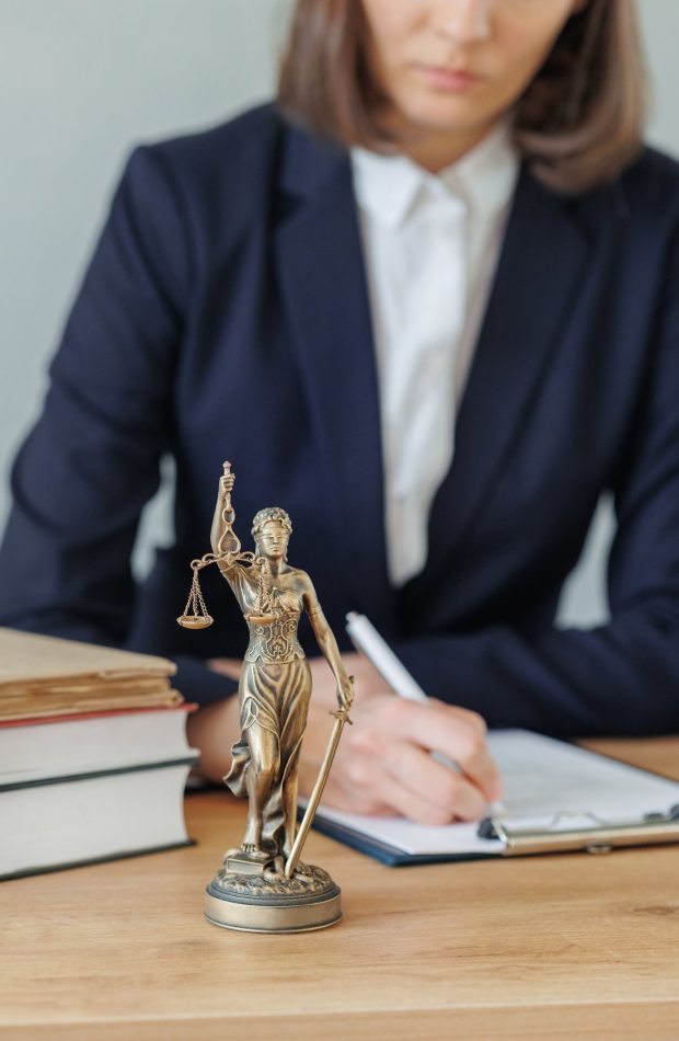 woman lawyer or a court representative sits in the office and checks the legal contract