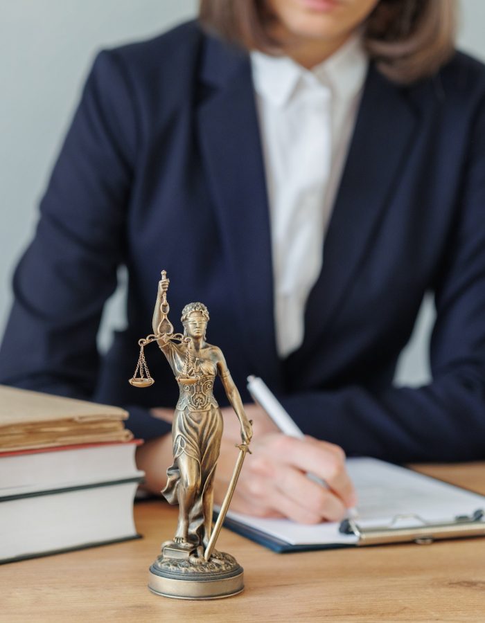 woman lawyer or a court representative sits in the office and checks the legal contract