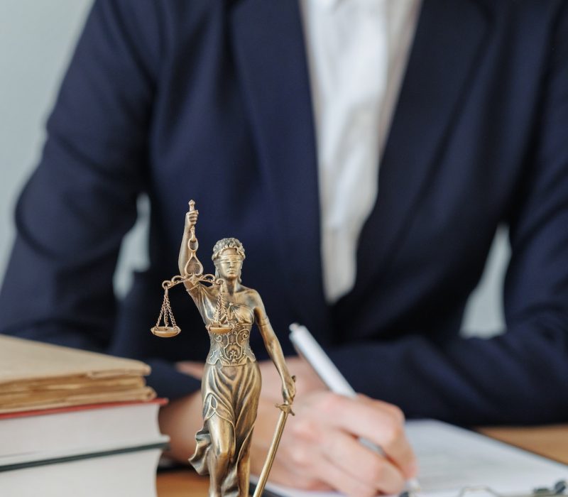 woman lawyer or a court representative sits in the office and checks the legal contract