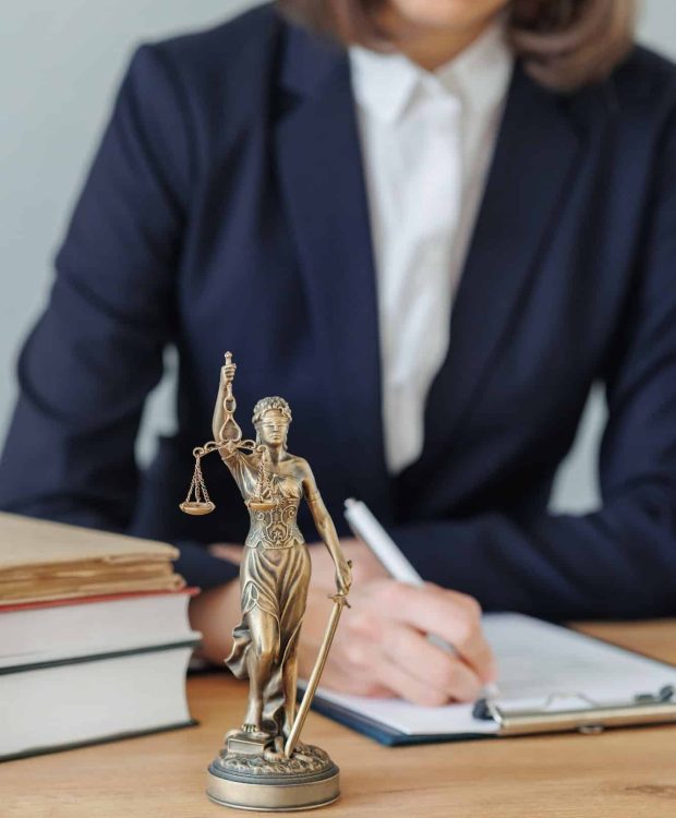 woman lawyer or a court representative sits in the office and checks the legal contract, Property Litigation Lawyer, Employment Law Solicitors London, Data Breach Lawyer