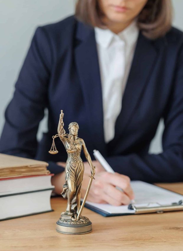 woman lawyer or a court representative sits in the office and checks the legal contract, Property Litigation Lawyer, Employment Law Solicitors London, Data Breach Lawyer