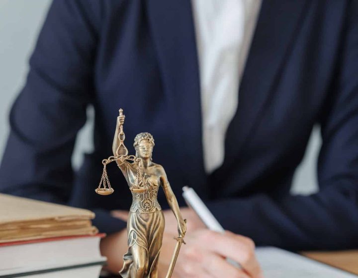 woman lawyer or a court representative sits in the office and checks the legal contract, Property Litigation Lawyer, Employment Law Solicitors London, Data Breach Lawyer