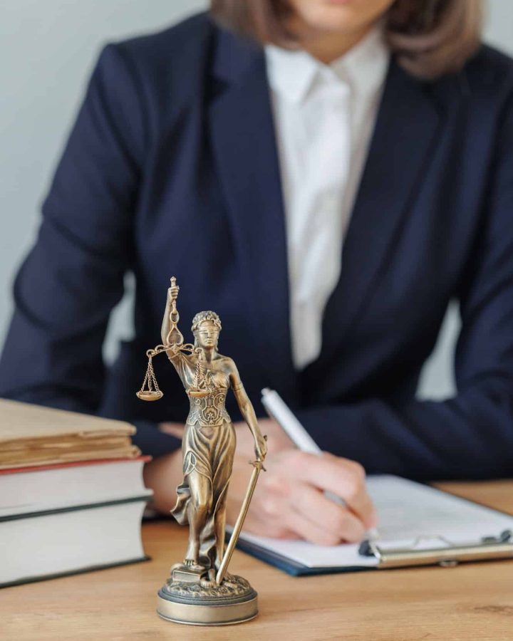 woman lawyer or a court representative sits in the office and checks the legal contract, Property Litigation Lawyer, Employment Law Solicitors London, Data Breach Lawyer