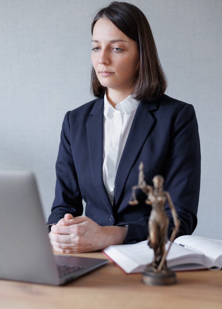 woman lawyer or lawyer in her office conducts an online consultation or webinar on legal services