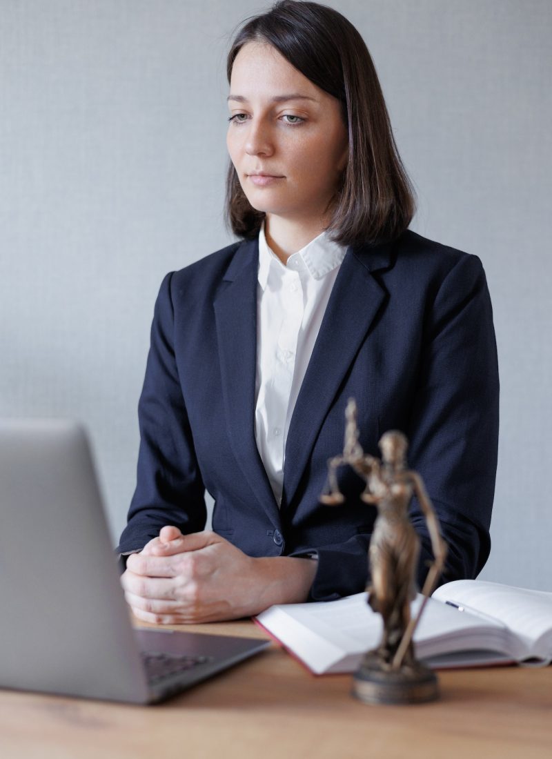 woman lawyer or lawyer in her office conducts an online consultation or webinar on legal services