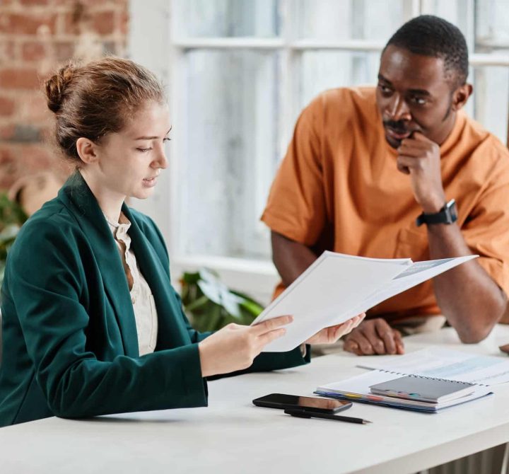 Young confident economist or lawyer checking documentation